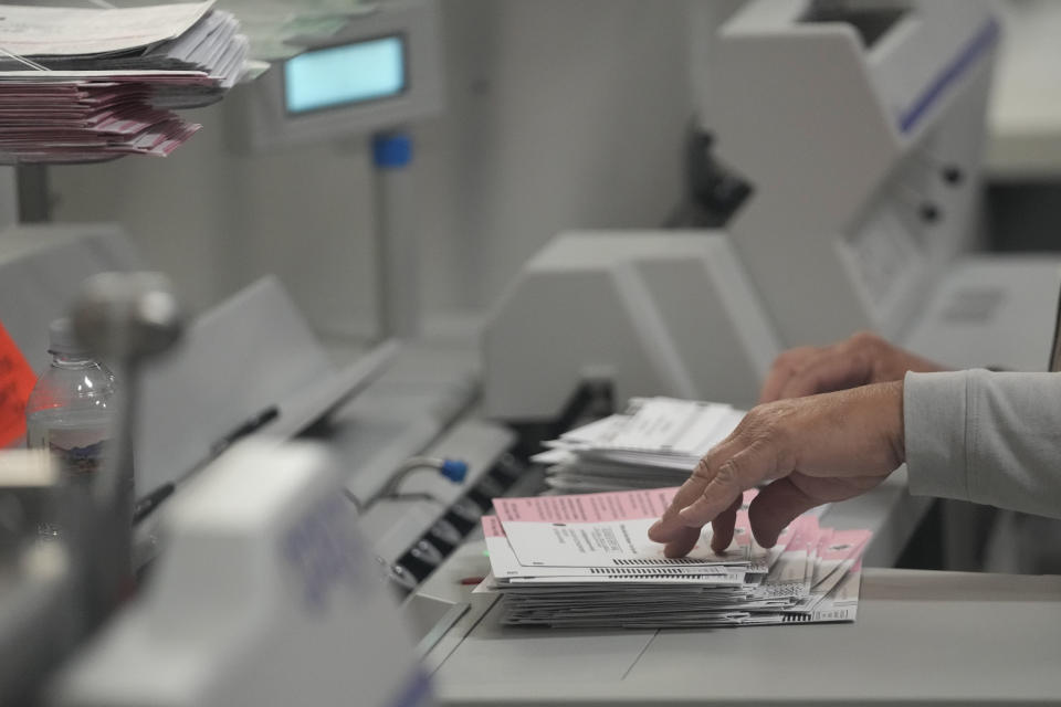 An election worker processes ballots at the Clark County Election Department, Thursday, Nov. 10, 2022, in Las Vegas. (AP Photo/Gregory Bull)