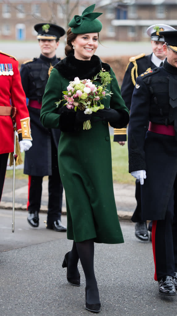<p>For the annual Irish Guards St Patrick’s Day Parade, the Duchess of Cambridge dressed her blossoming baby bump in emerald green. The 36-year-old chose a Catherine Walker coat accessorised with faux fur cuffs and collar by Gina Foster which she first donned back in 2013. <em>[Photo: Getty]</em> </p>