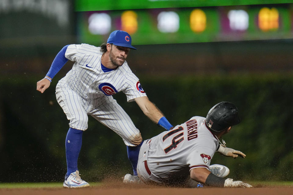 Chicago Cubs shortstop Dansby Swanson, left, tags out Arizona Diamondbacks' Gabriel Moreno at second for the second out of a double play hit into by Pavin Smith during the sixth inning of a baseball game Thursday, Sept. 7, 2023, in Chicago. (AP Photo/Erin Hooley)