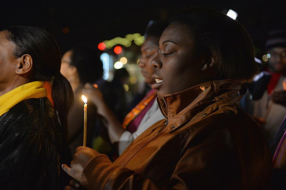 A woman participates in a candlelight memorial vigil near the Ferguson Police Department in Ferguson, Missouri on March 12, 2015. The troubled US community of Ferguson, Missouri -- scene of months of protests and racial tension -- was on a knife edge again after two police officers were shot.