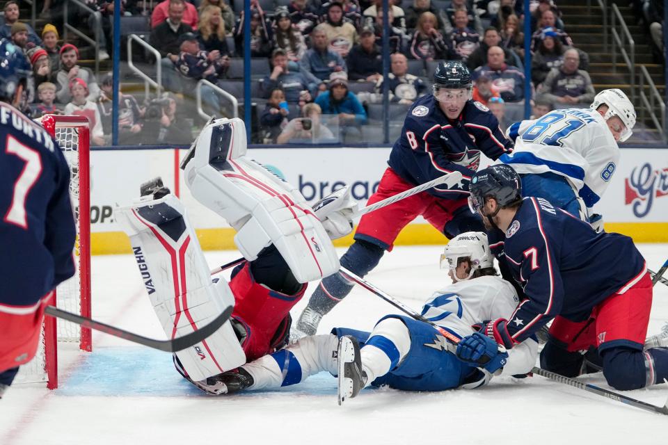 Oct 14, 2022; Columbus, Ohio, USA;  Columbus Blue Jackets center Sean Kuraly (7) hits Tampa Bay Lightning center Brayden Point (21) into goaltender Daniil Tarasov (40) during the second period of the NHL hockey game at Nationwide Arena. Mandatory Credit: Adam Cairns-The Columbus Dispatch