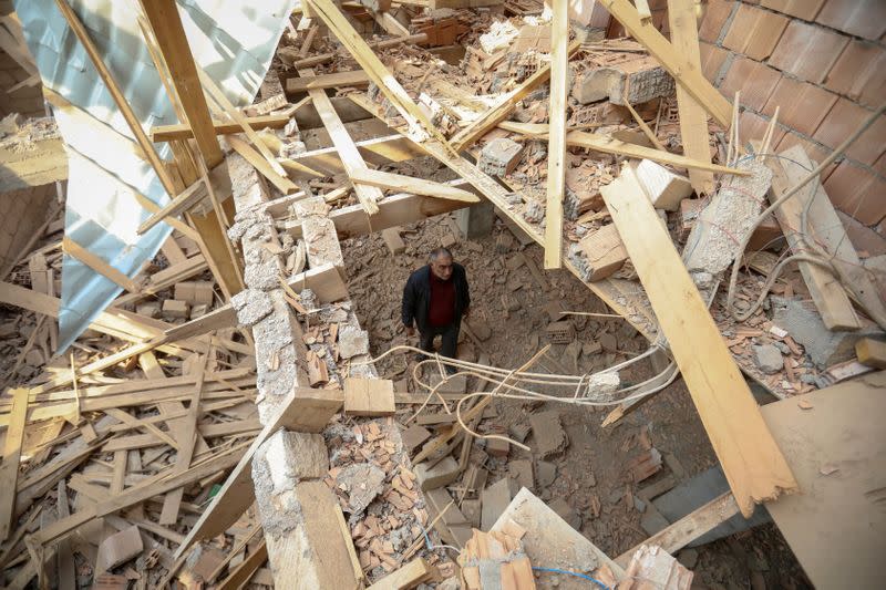 Local resident Elsever Pashayev stands in his house that was allegedly damaged by recent shelling during the fighting over the breakaway region of Nagorno-Karabakh, in the city of Tartar