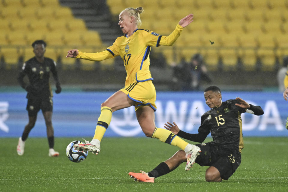 Sweden's Caroline Seger leaps over defender South Africa's Refiloe Jane during the Women's World Cup Group G soccer match between Sweden and South Africa in Wellington, New Zealand, Sunday, July 23, 2023. (AP Photo/Andrew Cornaga)