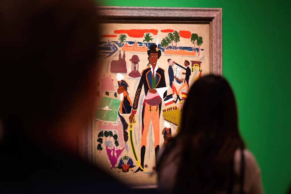 Visitors look Thursday at William H. Johnson's 1945 oil on paperboard painting of "Toussaint L 'Ouverture, Haiti" during a media tour of the traveling exhibit "Fighters for Freedom: William H. Johnson Picturing Justice" at the Oklahoma City Museum of Art.