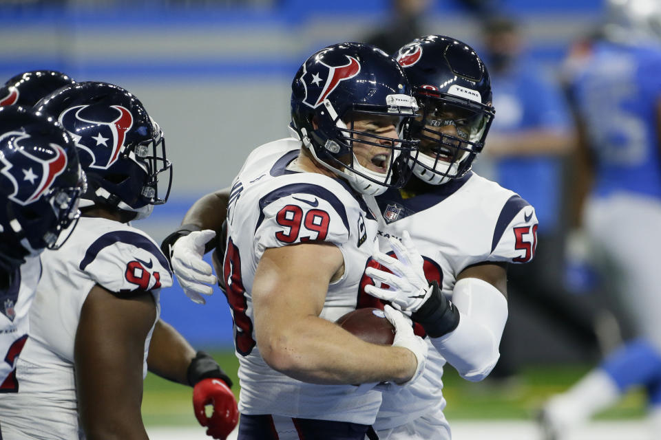 Houston Texans defensive end J.J. Watt (99) is congratulated after interception return for a touchdown during the first half of an NFL football game against the Detroit Lions, Thursday, Nov. 26, 2020, in Detroit. (AP Photo/Duane Burleson)