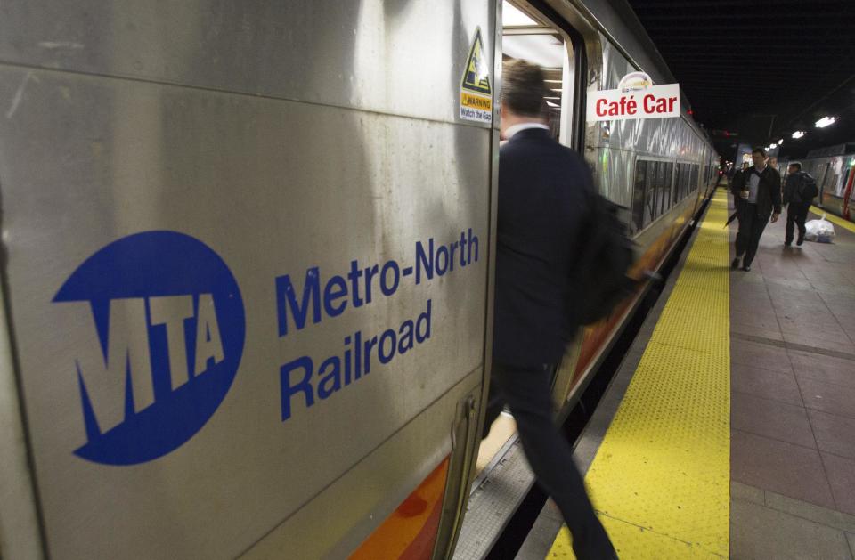 A commuter at Grand Central Terminal in New York boards the bar car on the 7:07 p.m. train to New Haven, Conn., on Thursday, May 8, 2014. Metro-North is retiring bar cars from the New Haven Line after Friday's afternoon rush hour. They were the last commuter bar cars in the U.S. (AP Photo/Michael R. Sisak)