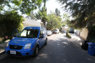 LOS ANGELES, CA - SEPTEMBER 27: News vans are seen near the the building (R) where actor Johnny Lewis was found dead on September 27, 2012 in Los Angeles, California. Lewis was found dead September 26, 2012 after apparently falling from the roof of the building he lived in. He is also a suspect in the death of a woman who is thought to have been his landlord and was found dead inside the house. (Photo by David Livingston/Getty Images)