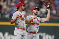 St. Louis Cardinals shortstop Paul DeJong (11) catches the game ending fly-out hit by Texas Rangers' Mitch Garver in front of left fielder Oscar Mercado (54) during the ninth inning of a baseball game, Wednesday, June 7, 2023, in Arlington, Texas. The Cardinals won 1-0. (AP Photo/Jim Cowsert)