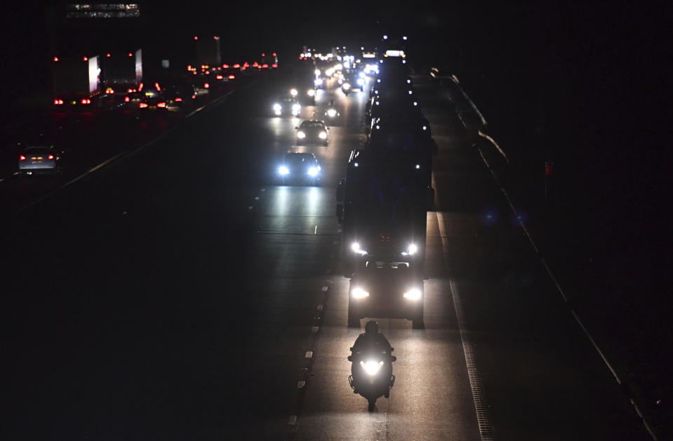 Buses carrying British nationals from the coronavirus-hit city of Wuhan in China, as they travel in convoy with a police escort towards the Arrowe Park Hospital in Liverpool, England, Friday Jan. 31, 2020. A civilian passenger plane carrying British evacuees from China landed Friday carrying eighty-three Britons who are being transported to hospital where they are set to be quarantined to monitor for symptoms of virus infection. (Jacob King/PA via AP)