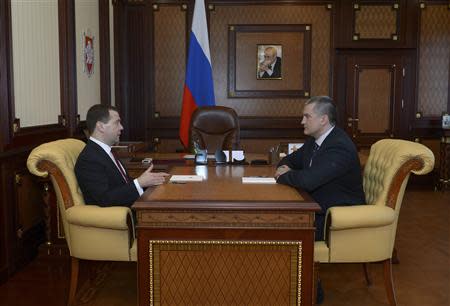 Russia's Prime Minister Dmitry Medvedev (L) meets with Crimea's Prime Minister Sergei Aksyonov in Simferopol, March 31, 2014. REUTERS/RIA Novosti/Alexander Astafyev/Pool