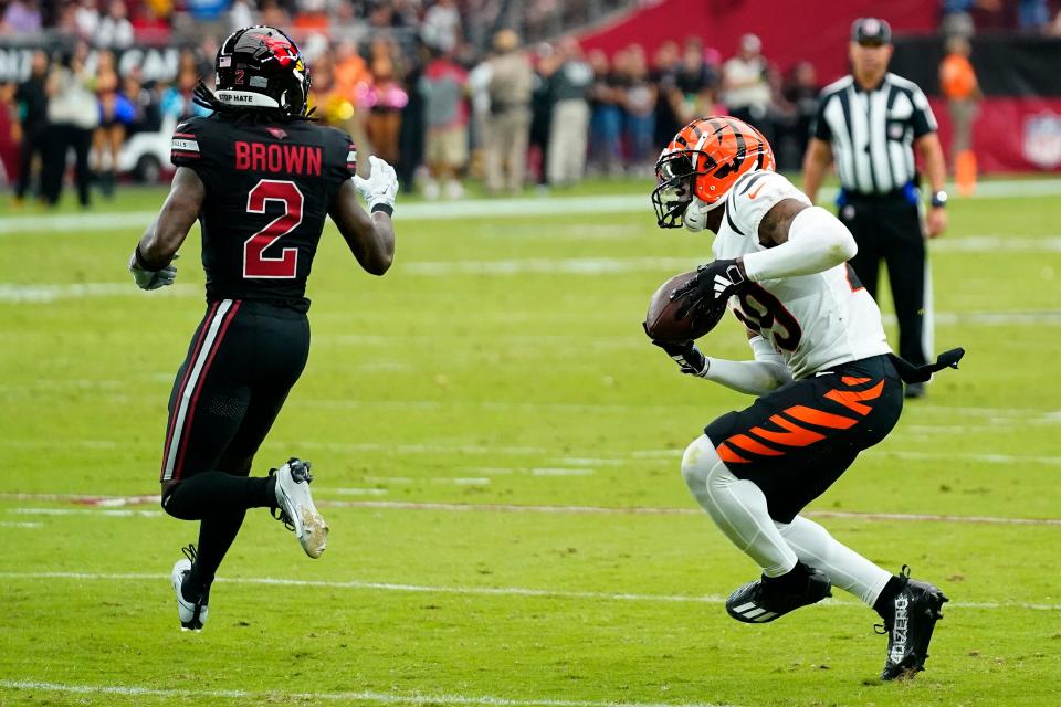 Cincinnati Bengals cornerback Cam Taylor-Britt intercepts a pass intended for Arizona Cardinals wide receiver Marquise Brown (2) for touchdown during the first half of an NFL football game, Sunday, Oct. 8, 2023, in Glendale, Ariz.