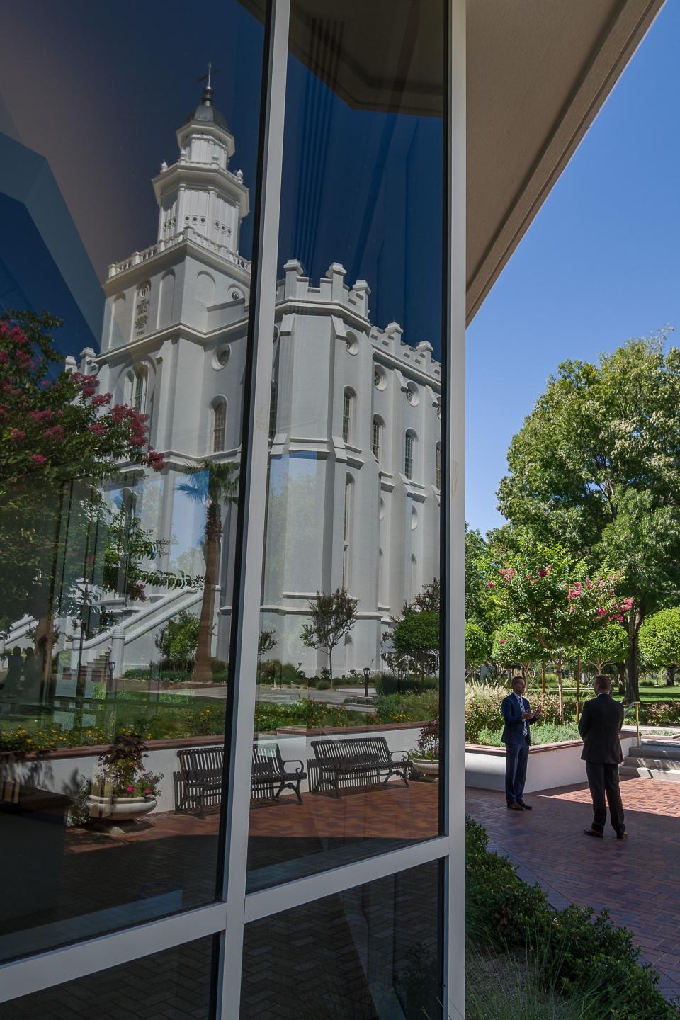 Matthew Godfrey, left, senior managing historian for The Church of Jesus Christ of Latter-day Saints, gives an interview about the church’s newly renovated St. George Utah Temple, reflected in the visitor center window, in St. George, Utah, on Wednesday, Sept. 6, 2023, in St. George, Utah. | Nick Adams, for the Deseret News