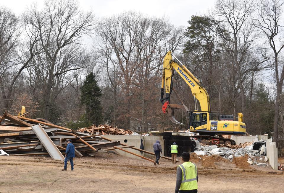 Demolition workers are razing a 20,000-square-foot house that remained uncompleted for years in Cherry Hill's Voken Tract neighborhood.