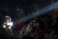 <p>A child holds a bowl of hot food as the Avila family has lunch at their home in Coata, a small village on the shore of Lake Titicaca in the Puno region of Peru on Feb. 4, 2017. Lake Titicaca was once worshipped by Incas who proclaimed its deep blue waters the birthplace of the sun, but today, high levels of mercury, cadmium, zinc and copper are found in the fish locals consume, according to a 2014 government study. (Photo: Rodrigo Abd/AP) </p>