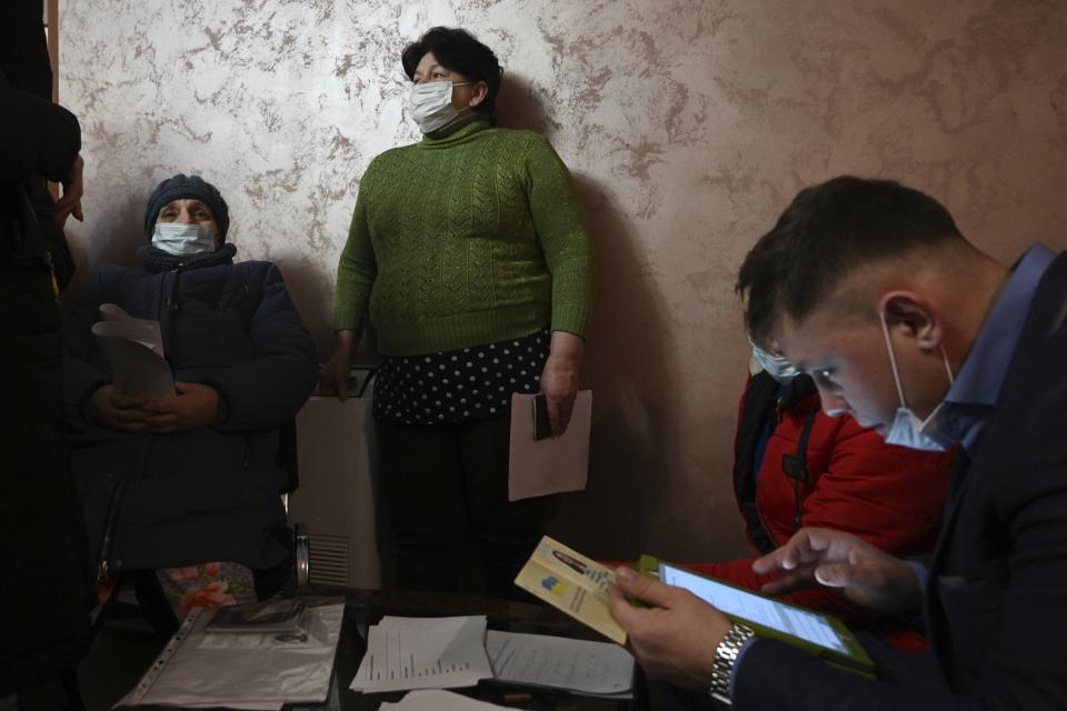 People from Donetsk, the territory controlled by a pro-Russia separatist government in eastern Ukraine, gather to fill in documents after evacuating in the Rostov-on-Don region, near the border with Ukraine, Russia, Sunday, Feb. 20, 2022. Russia is extending military drills near Ukraine’s northern borders after two days of sustained shelling along the contact line between Ukrainian soldiers and Russia-backed separatists in eastern Ukraine. The exercises in Belarus, which borders Ukraine to the north, originally were set to end on Sunday. (AP Photo)