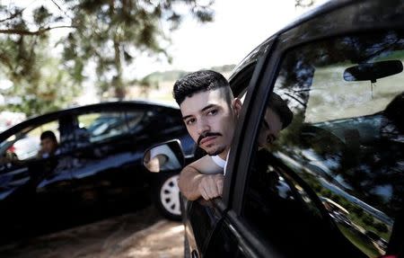 Uber drivers sit in their cars as they wait for passengers in Sao Paulo, Brazil, February 13, 2017. REUTERS/Nacho Doce