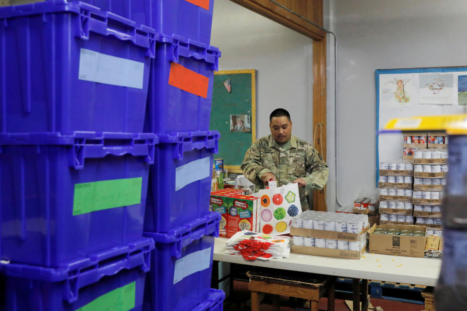 P.F.C. Sison of the New York Army National Guard helps pack pantry bags for food distribution with Hope Community Services in an area with multiple cases of coronavirus disease (COVID-19) in New Rochelle, New York, U.S., March 18, 2020. (Andrew Kelly/Reuters)