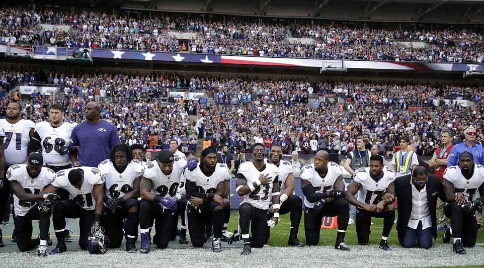 Baltimore Ravens players kneel at Wembley (AP)