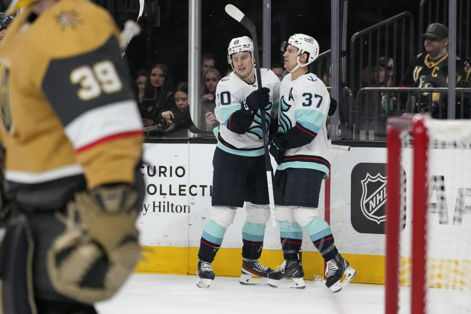 Seattle Kraken center Yanni Gourde, right, celebrates after scoring against the Vegas Golden Knights during the first period of an NHL hockey game Tuesday, April 11, 2023, in Las Vegas. (AP Photo/John Locher)