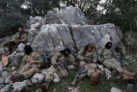 Turkish-backed Free Syrian Army fighters rest near the city of Afrin, Syria February 19, 2018. REUTERS/Khalil Ashawi