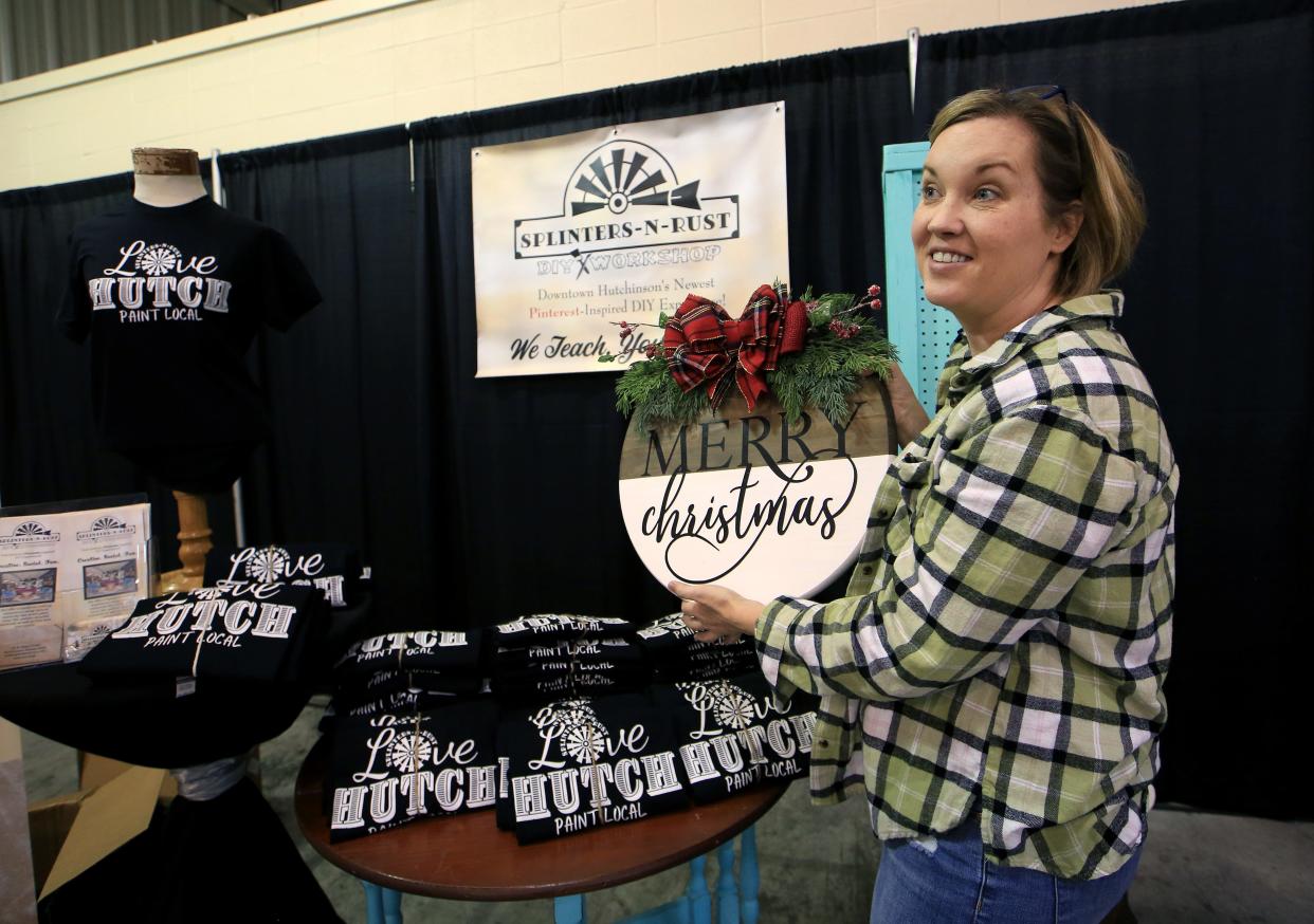 Janice Richardson, Artist & Owner of Splinters-N-Rust, shows one of the many examples of what people can create at her DIY Workshop business during Friday's Ignite! Business Expo, a business networking event, held on  Nov. 5, 2021 in the Sunflower North and South buildings at the Kansas State Fairgrounds.