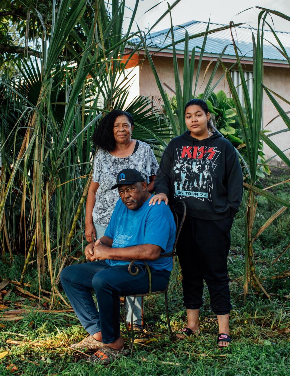 Debra Jones, a retired schoolteacher and Pahokee resident, suffers from respiratory issues. Her husband Edward Jones, who suffers from cancer, and their daughter (adopted granddaughter) are pictured outside of their home in Pahokee, Florida.