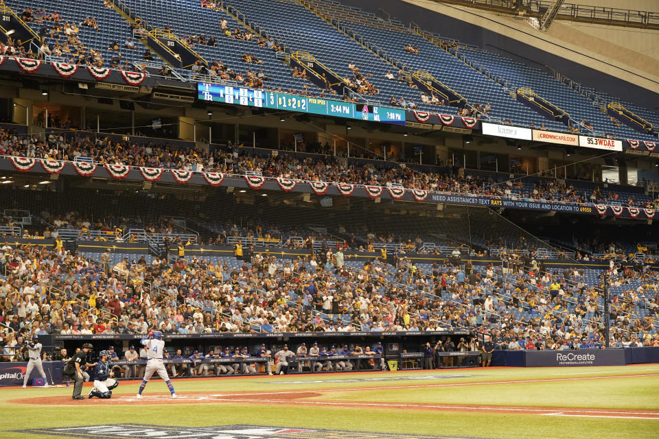 Fans watch, some among empty seats during the third inning of Game 2 in an AL wild-card baseball playoff series between the Tampa Bay Rays and the Texas Rangers, Wednesday, Oct. 4, 2023, in St. Petersburg, Fla. (AP Photo/John Raoux)