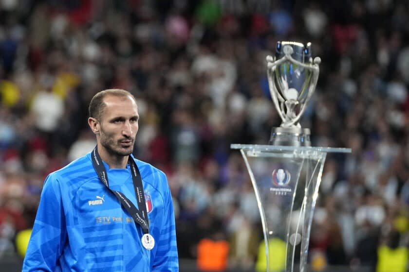Italy's Giorgio Chiellini walks past the trophy at the end of the Finalissima soccer match