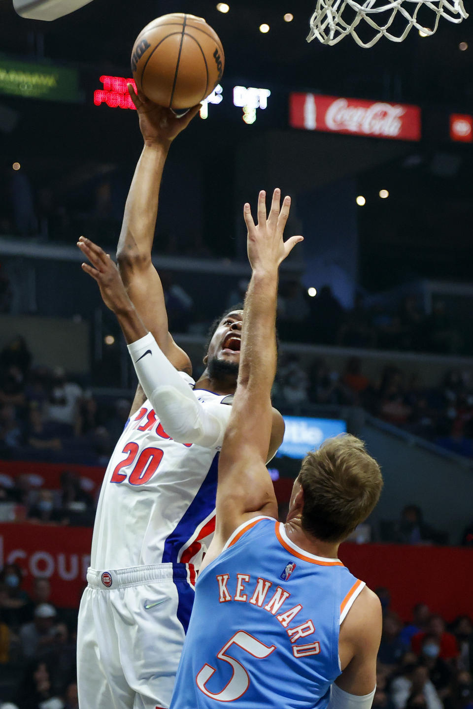 Detroit Pistons guard Josh Jackson (20) shoots against Los Angeles Clippers guard Luke Kennard (5) during the first half of an NBA basketball game, Friday, Nov. 26, 2021, in Los Angeles. (AP Photo/Ringo H.W. Chiu)