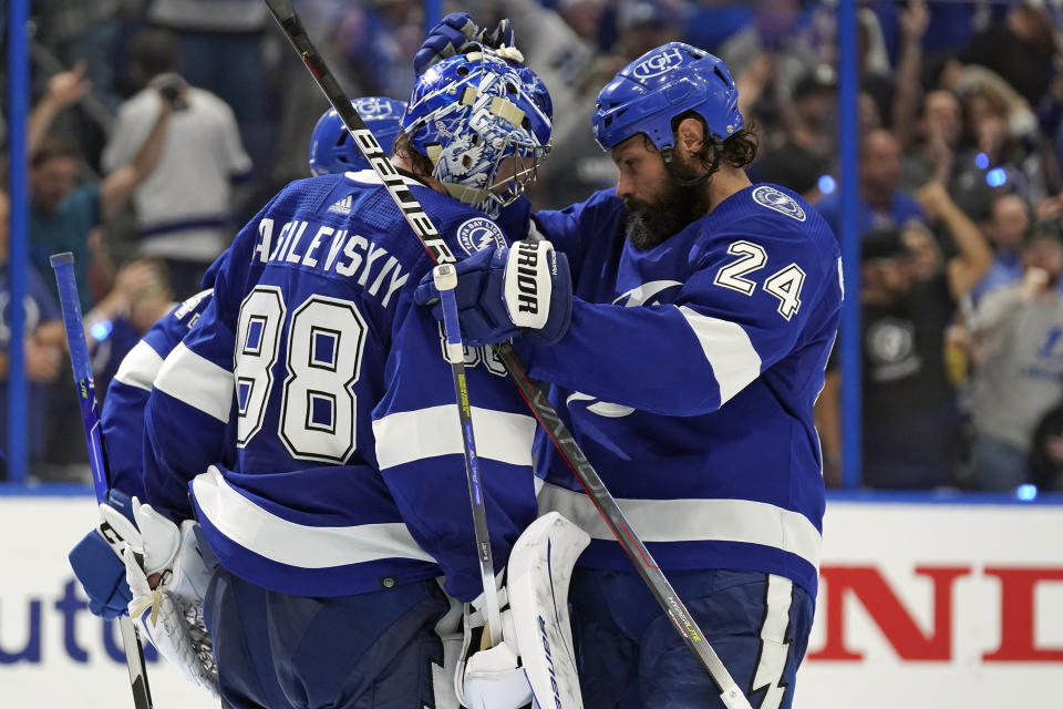 Tampa Bay Lightning goaltender Andrei Vasilevskiy (88) celebrates with defenseman Zach Bogosian (24) after the team defeated the New York Rangers during Game 4 of the NHL hockey Stanley Cup playoffs Eastern Conference finals Tuesday, June 7, 2022, in Tampa, Fla. (AP Photo/Chris O'Meara)