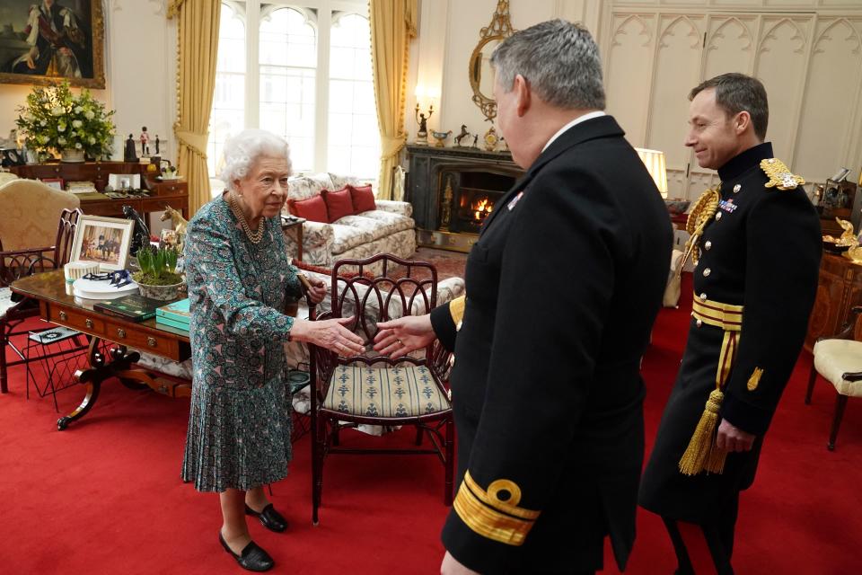 Queen Elizabeth II (L) welcomes outgoing Defence Service Secretaries Rear Admiral James Macleod (R) and incoming Defence Service Secretaries Major General Eldon Millar (C) during an in-person audience at the Windsor Castle