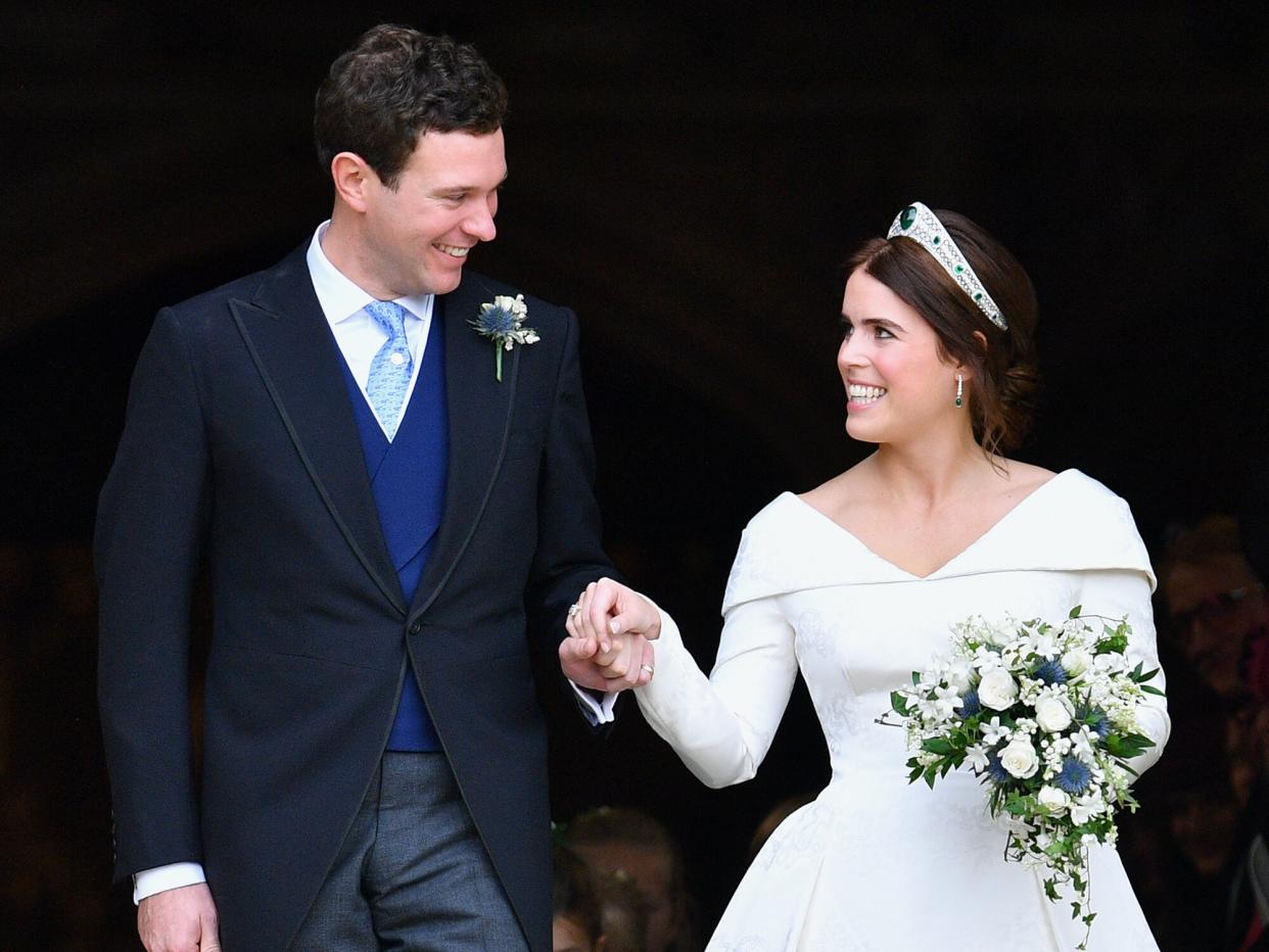 Jack Brooksbank and Princess Eugenie leave St George's Chapel after their wedding ceremony on October 12, 2018 in Windsor, England