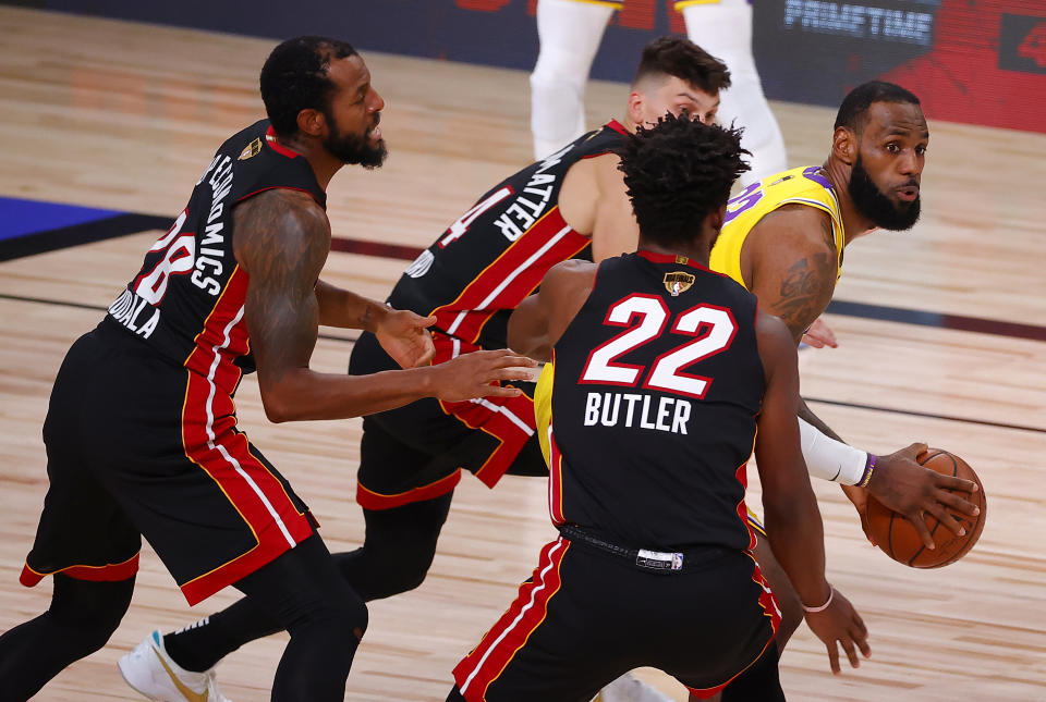 LAKE BUENA VISTA, FLORIDA - SEPTEMBER 30: Andre Iguodala #28 of the Miami Heat, Tyler Herro #14 of the Miami Heat and Jimmy Butler #22 of the Miami Heat  defend LeBron James #23 of the Los Angeles Lakers during the second quarter in Game One of the 2020 NBA Finals  at AdventHealth Arena at the ESPN Wide World Of Sports Complex on September 30, 2020 in Lake Buena Vista, Florida. NOTE TO USER: User expressly acknowledges and agrees that, by downloading and or using this photograph, User is consenting to the terms and conditions of the Getty Images License Agreement.  (Photo by Kevin C. Cox/Getty Images)