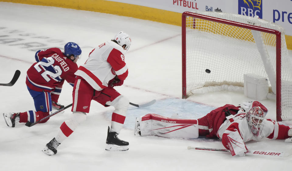 Montreal Canadiens' Cole Caufield (22) scores on Detroit Red Wings goaltender James Reimer (47) during the second period of an NHL hockey game Tuesday, April 16, 2024, in Montreal. (Christinne Muschi/The Canadian Press via AP)