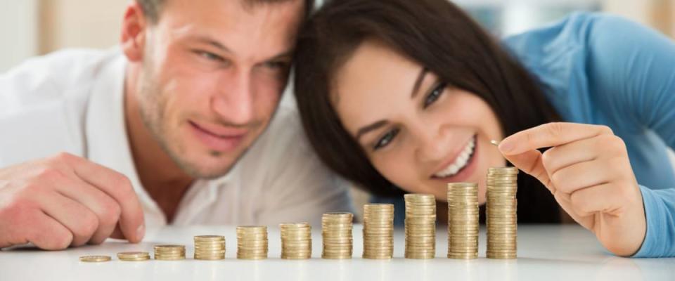 young couple counting their coins on a countertop