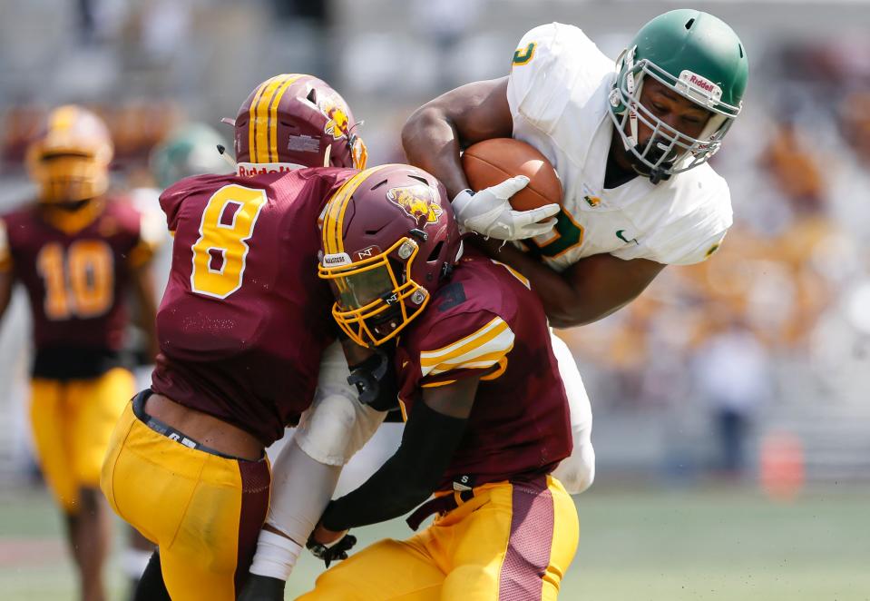 Kentucky State running back Brett Sylve is stopped by Central State defensive backs Keandre Powell (8) and Malik Johnson (3) during the first quarter of the HBCU Classic For Columbus at Ohio Stadium on Saturday, Aug. 28, 2021.