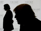 <p>Trump, right, talks with the Associated Press as his son Donald Jr. gives an interview during the topping-off festivities for the 92-story Trump International Hotel and Tower in Chicago, Sept. 24, 2008. Trump, commenting on the economic bailout, said the $700 billion plan was probably necessary because it looked like the economy was “rushing into one big depression.” <i>(Photo: Charles Rex Arbogast/AP)</i> </p>