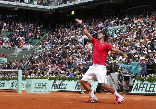 Spain's Rafael Nadal serves to David Ferrer during their French Open semi-final match on June 8. Nadal defeated his fellow Spaniard Ferrer 6-2, 6-2, 6-1 on Friday to reach the French Open final where he will bid to become the first man to win seven titles at Roland Garros