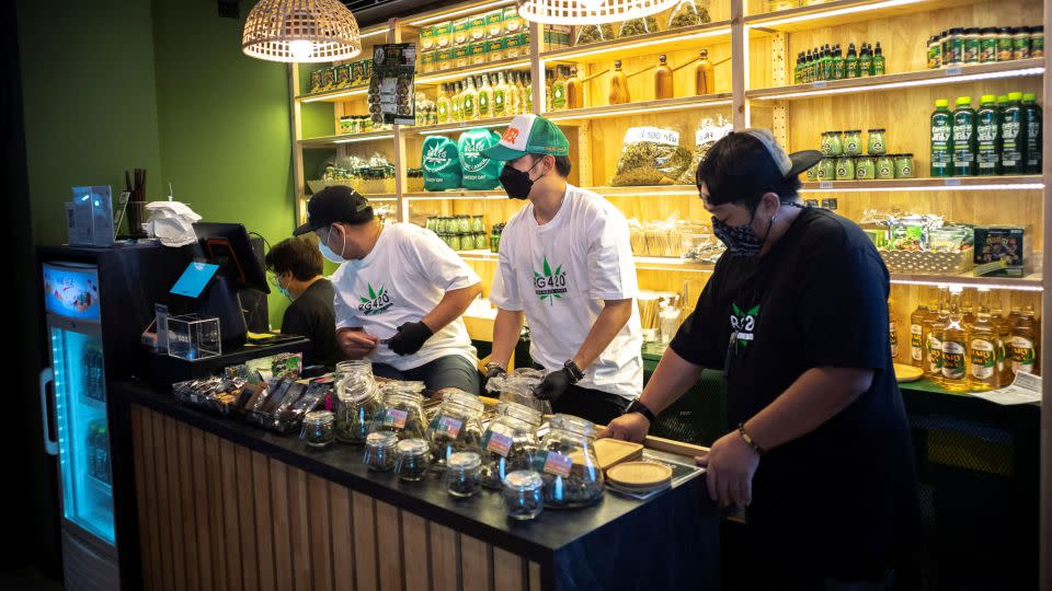 Staff prepare cannabis at a store along Bangkok's popular Khaosan Road. - Athit Perawongmetha/Reuters