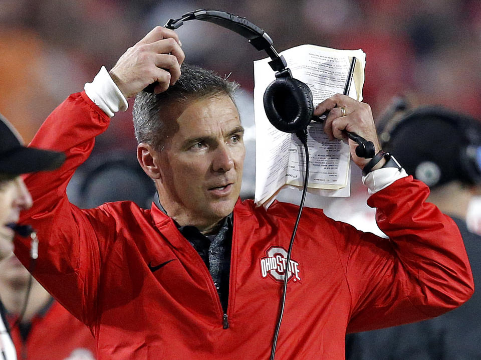 FILE – In this Dec. 31, 2016, file photo, Ohio State head coach Urban Meyer takes off his headset during the second half of the Fiesta Bowl NCAA college football game against Clemson, in Glendale, Ariz. A three-way quarterback derby promises to lend some intrigue to Ohio State’s spring practice that opened on Tuesday, March 6, 2018. (AP Photo/Ross D. Franklin, File)