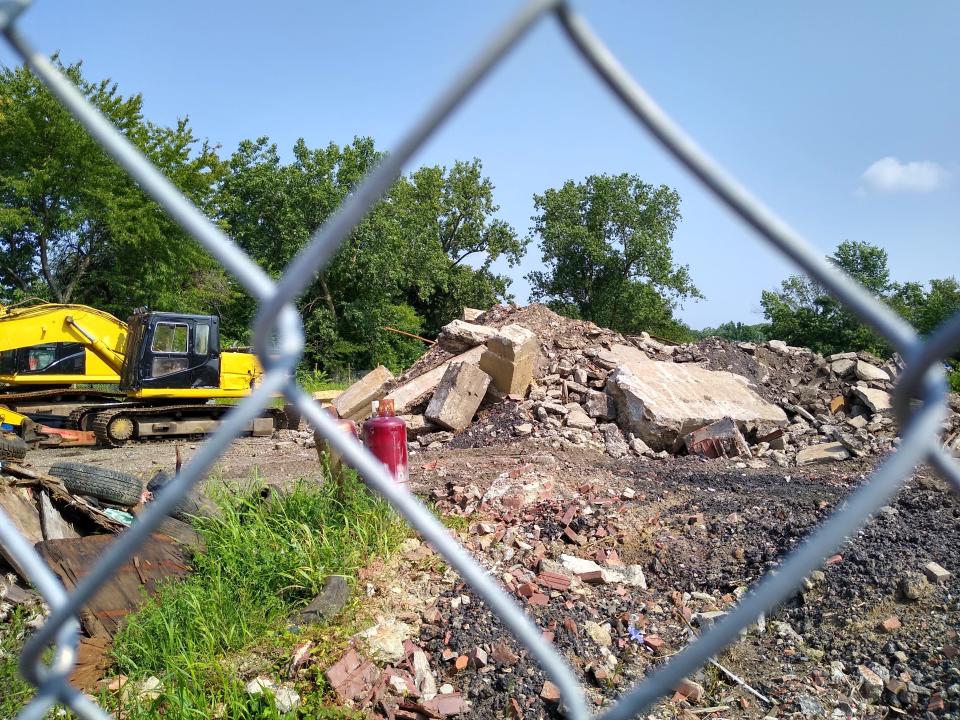 A chain-link fence cordons off the former site of L.E. Shunk Latex Products on Morgan Avenue in South Akron.