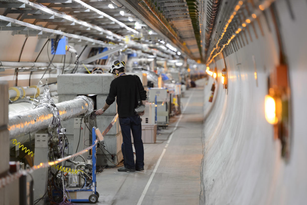 A technician works in the Large Hadron Collider tunnel of the European Organization for Nuclear Research, CERN. (Laurent Gillieron/Keystone via AP)