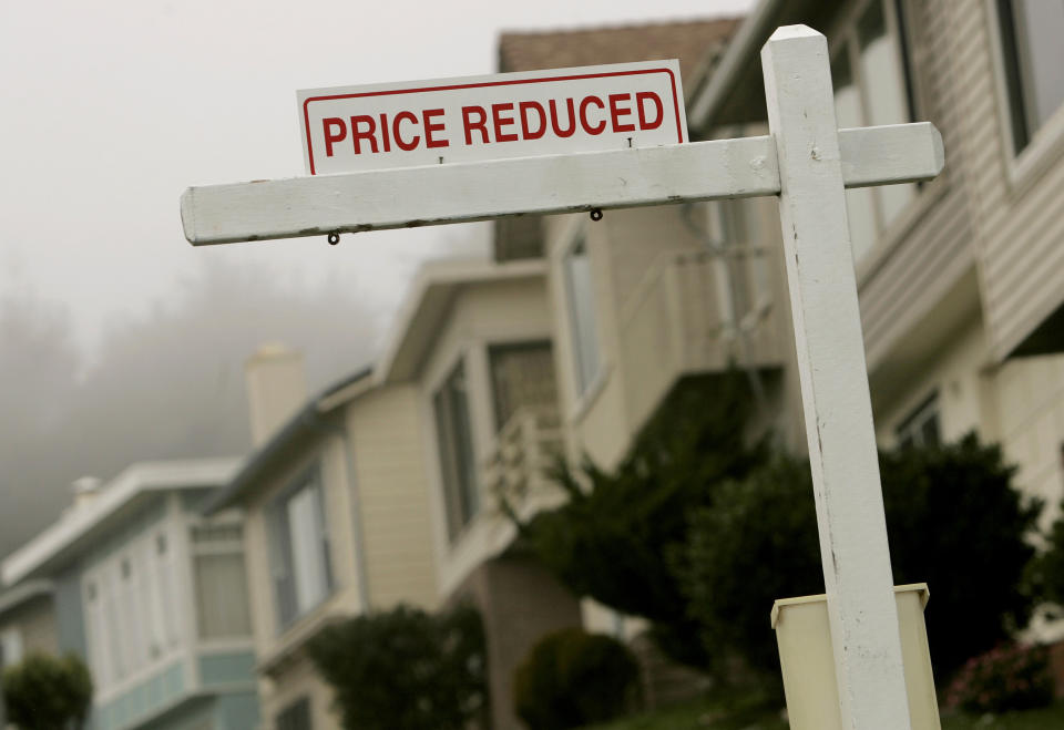 A sign advertising a home for sale at a reduced price is shown in Pacifica, California in 2008.