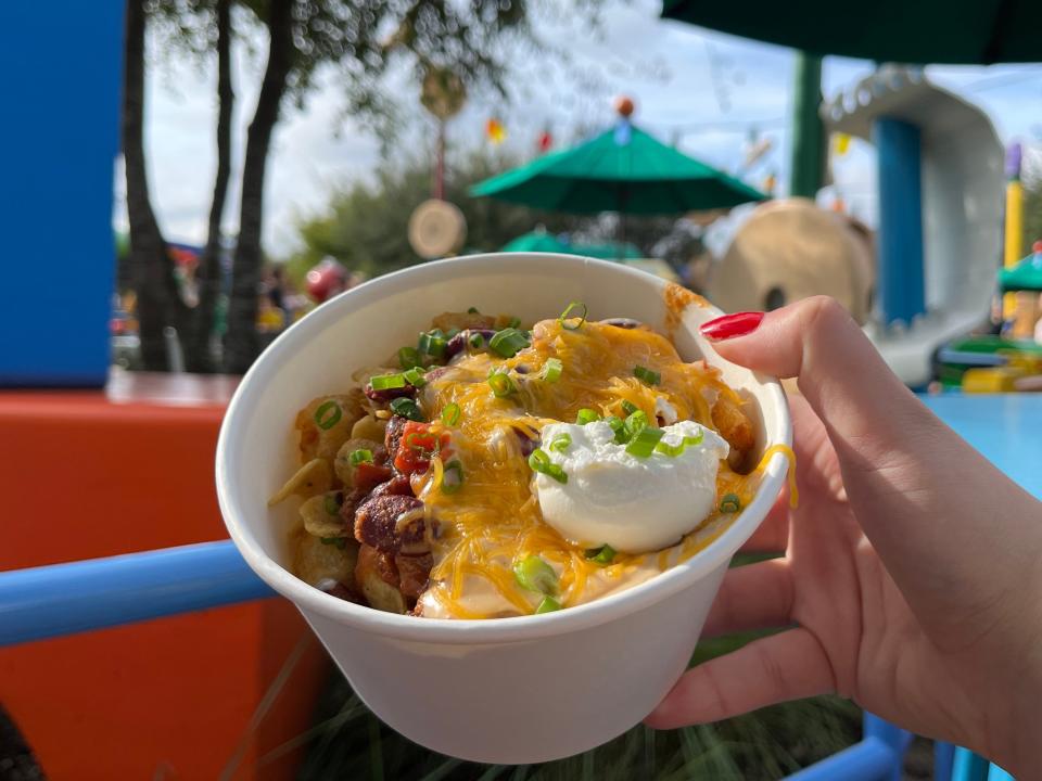 hand holding bowl of tachos from woody's lunchbox in hollywood studios