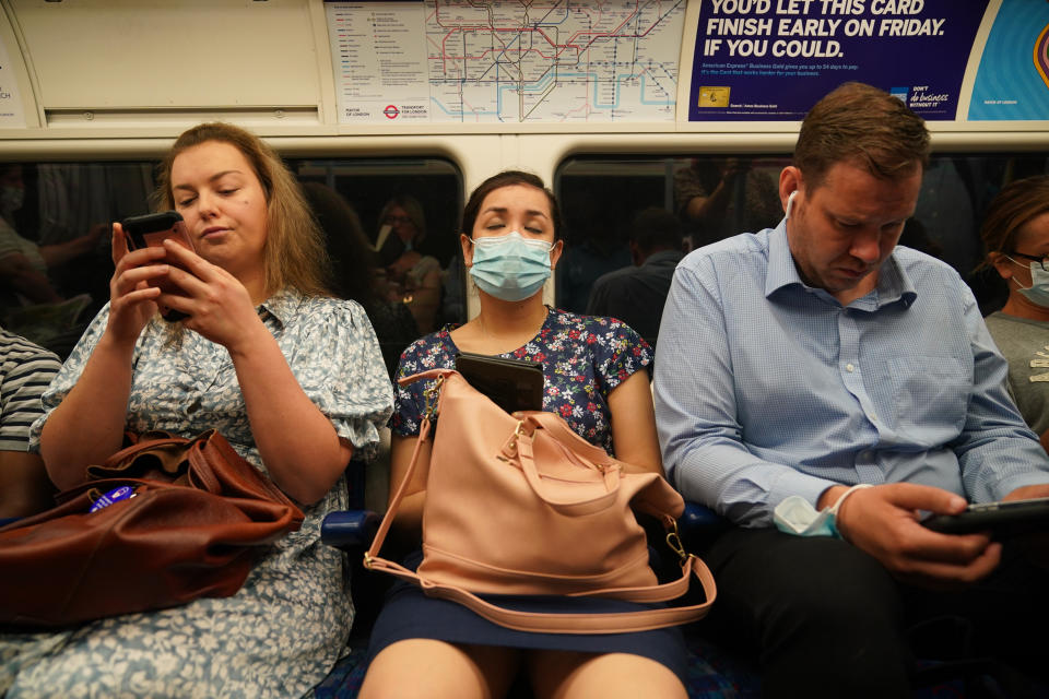 Commuters, some not wearing facemasks, on a Jubilee Line tube train to Westminster at 0822 in London after the final legal Coronavirus restrictions were lifted in England. Picture date: Monday July 19, 2021.