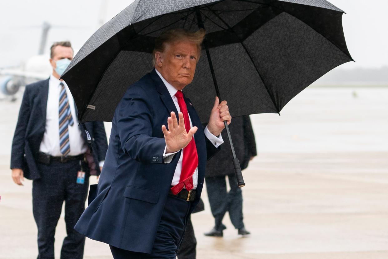 President Donald Trump boards Air Force One for a campaign rally in Sanford, Florida, on Monday, 12 October, 2020 (AP)