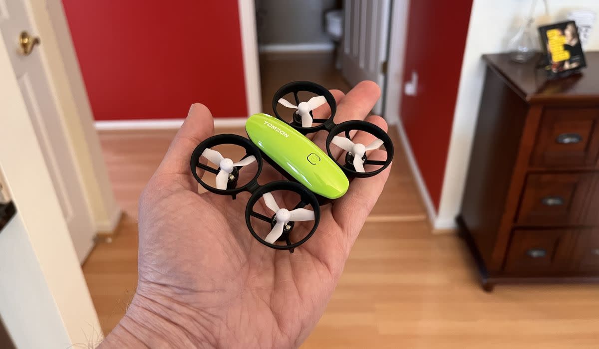 Tomzon's A23 mini drone shown for size; it fits in the palm of a hand.