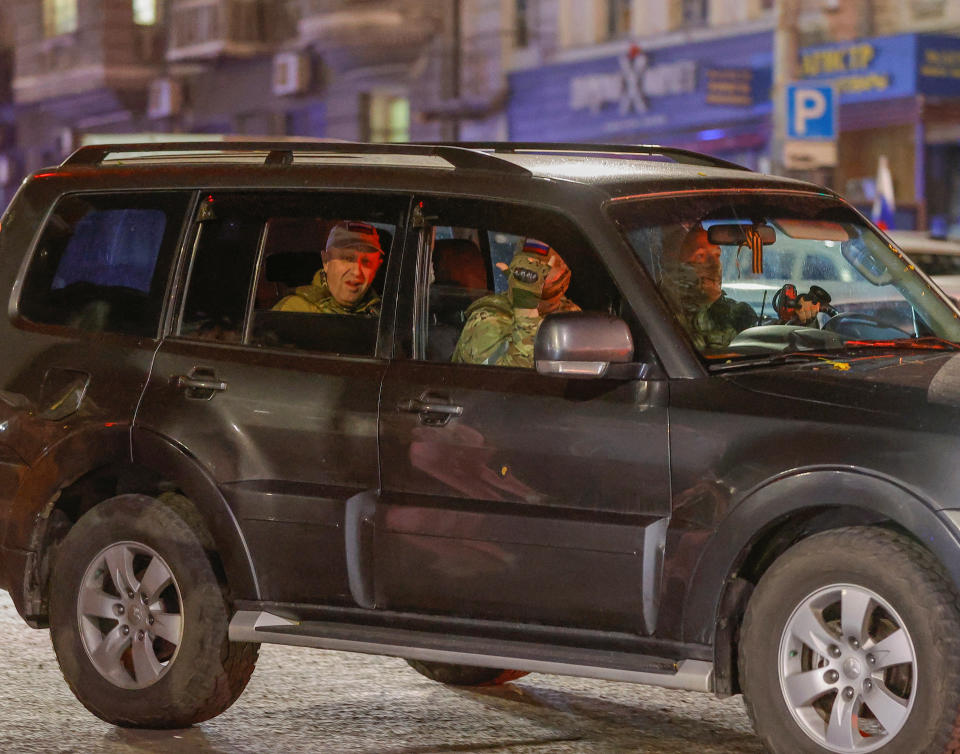 Prigozhin seated in the back of an SUV.