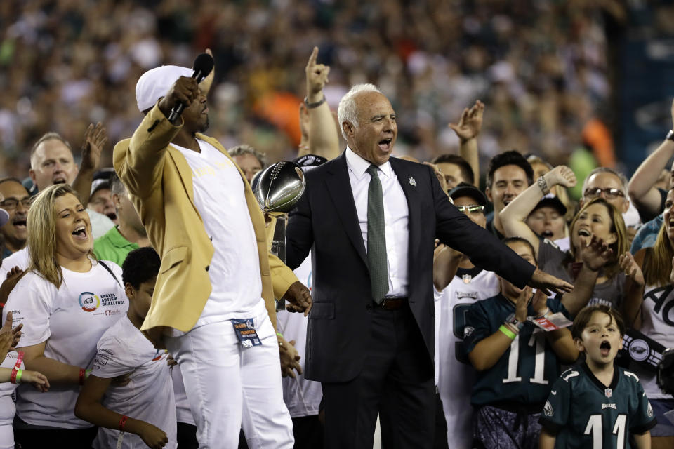 Philadelphia Eagles owner Jeffrey Lurie reacts alongside Brian Dawkins during a ceremony before the team's NFL football game against the Atlanta Falcons, Thursday, Sept. 6, 2018, in Philadelphia. (AP Photo/Michael Perez)