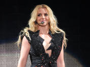 In this Sept. 27, 2011 file photo, singer Britney Spears performs on a stage during a concert in Kiev, Ukraine, during her European Femme Fatale Tour. A source says she is joining Simon Cowell's singing contest as a judge on the singing competition series "The X-Factor." (AP Photo/Leonid Naidiouk, file)